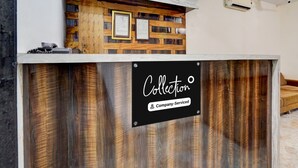 A reception desk with a wooden panel design, a sign indicating 'Collection & Company-Serviced,' and a ceiling with recessed lighting and an air conditioning unit. - Classic With Balcony Daulatabad Fort Aurangabad (Chhatrapati Sambhajinagar)
