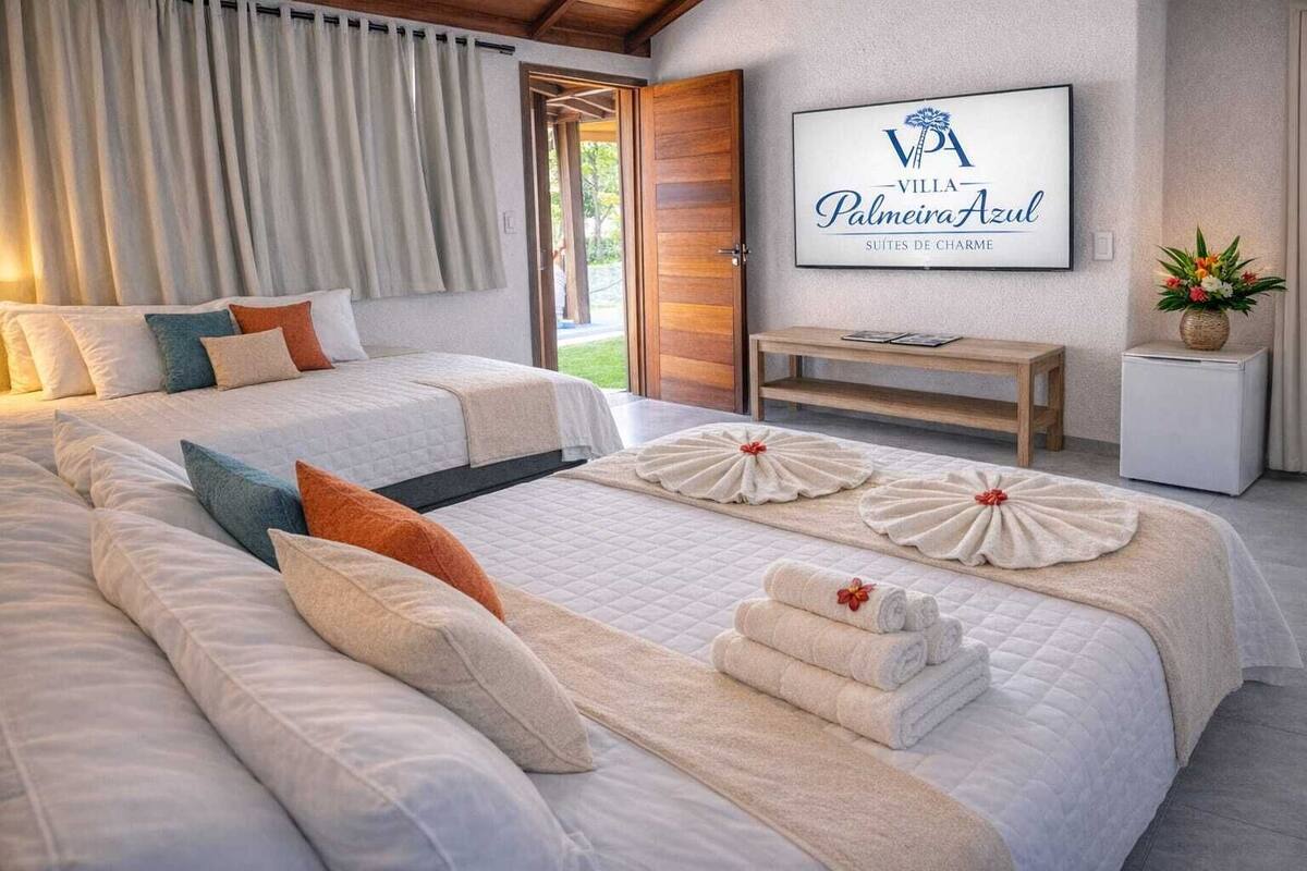 A hotel room with two beds, a TV, a small table, and a wall-mounted sign.