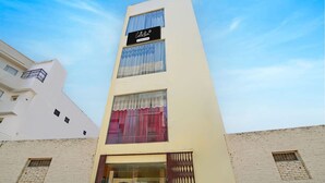 A multi-story building with a sign reading 'Collection 6 Collection Store.' - Classic Prayagraj Bus Stop Sonica Gold (Prayagraj)