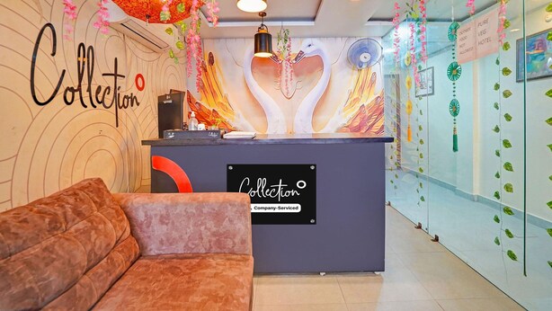 A reception area with a sofa, a sign reading 'Collection,' and a wall with a heart-shaped design. - Classic Prayagraj Bus Stop Sonica Gold (Prayagraj)