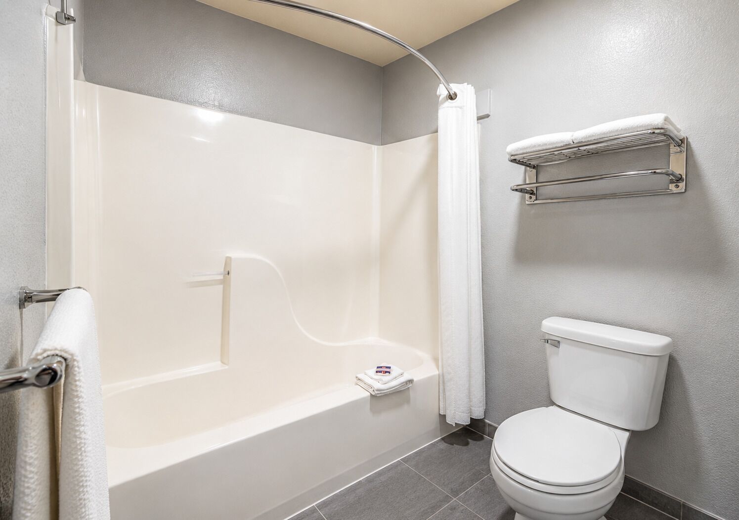 Combined shower/bathtub, towels, toilet paper