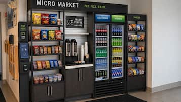A micro market with a coffee station, snack and cold drink vending machines, and a payment kiosk.