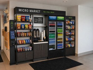 A micro market with a coffee station, snack and cold drink vending machines, and a payment kiosk. - Hotel Blu (Columbia)