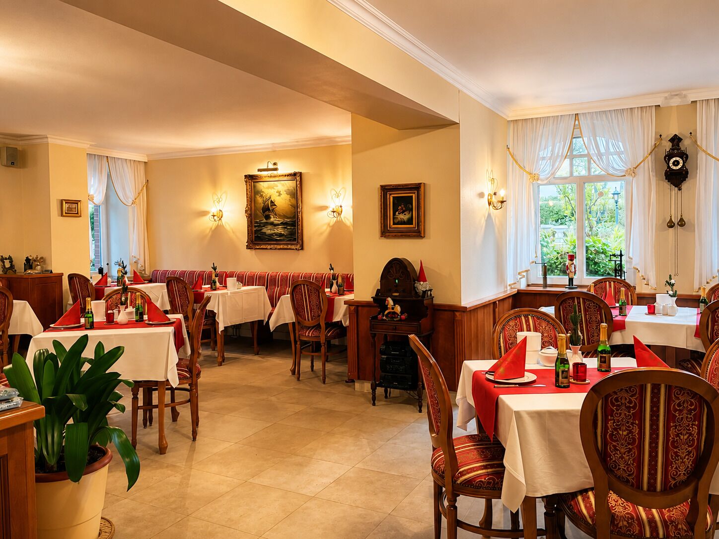 A dining area with tables set for service, a clock on the wall, and a painting above the tables.