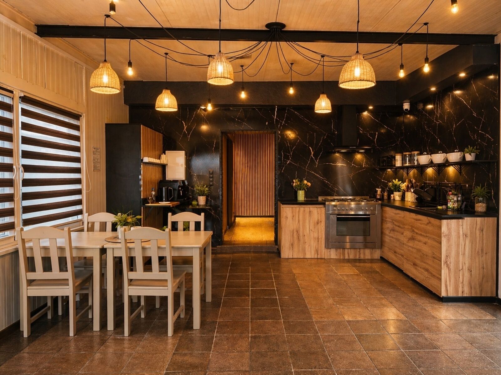 A modern kitchen with a wooden island, a dining area with chairs, and pendant lighting.