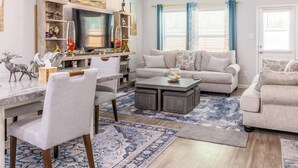 A living room with a sofa, coffee table, and decorative items. - Woodridge (Porter)