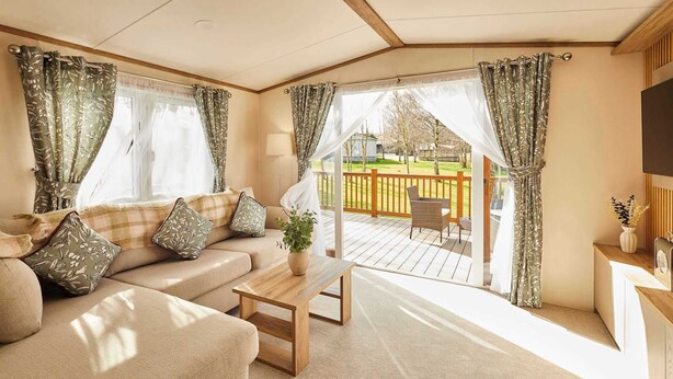 A cozy living room with a sofa, a coffee table, and curtains. - Host & Stay | Molly's Place (Morpeth)