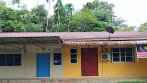 A building with a red door, a blue door, and a satellite dish.