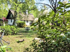 A rustic house with a thatched roof, surrounded by greenery and a clear sky. - 6 Person Holiday Home in Frederiksvaerk (Frederiksvaerk)