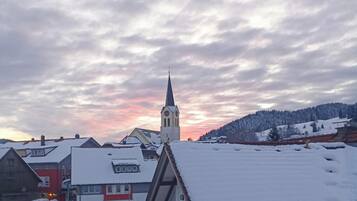 Ein verschneites Dorf mit Kirche und Wohnhäusern.