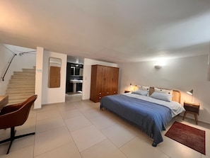 A bedroom with a bed, a wooden wardrobe, a desk, and a chair. - 1900 traditional house in Grimaud (Grimaud)
