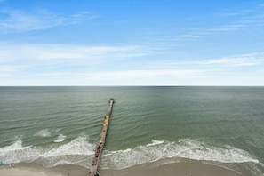 A long pier extending into calm waters with a clear sky above. - Prince Resort 1904- Oceanfront 2 Bedroom-Pool (North Myrtle Beach)