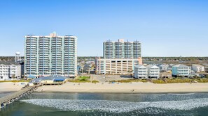 A coastal cityscape with high-rise buildings, a beach, and a pier. - Prince Resort 1904- Oceanfront 2 Bedroom-Pool (North Myrtle Beach)