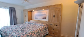 A bedroom with a bed, a large window with curtains, a ceiling fan, and a painting above the bed. - Waterway front 2-BR 2 bath condo Boat Ramp & Dock Tennis, Pool Myrtle Beach (Myrtle Beach)