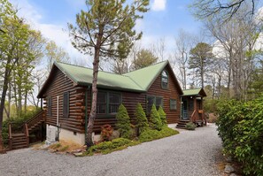 A log cabin with a green roof, a wooden staircase, and a gravel driveway. - Blue Ridge Retreat w/ Private Trail (Pisgah Forest)