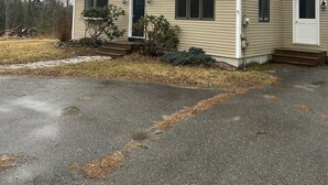 A two-story building with a front entrance, a small porch, and a garage. - Peaceful 4-bedroom house in charming Castine perfect for relaxing stays (Castine)