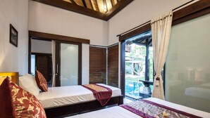 A hotel room with two beds, a large window, and a view of an outdoor area. - Huge Private Pool Villa Atala Canggu Seminyak 4BR (Kerobokan)