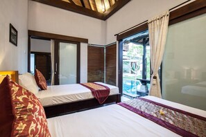 A hotel room with two beds, a large window, and a view of an outdoor area. - Huge Private Pool Villa Atala Canggu Seminyak 4BR (Kerobokan)