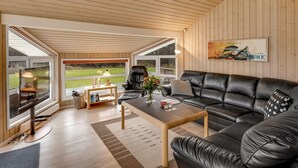Een moderne woonkamer met een leren bank, een salontafel en een televisie.