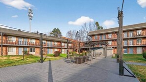 A multi-story brick building with a covered outdoor patio area.