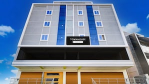 A multi-story building with a sign reading 'TOWNHOUSE' and 'Company Serviced.' - Saver Single Karmanghat Midtown (Hyderabad)