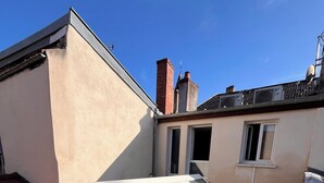 A rooftop with skylights and a red-tiled roof. - DOUCE NUITS (Nuits-Saint-Georges)