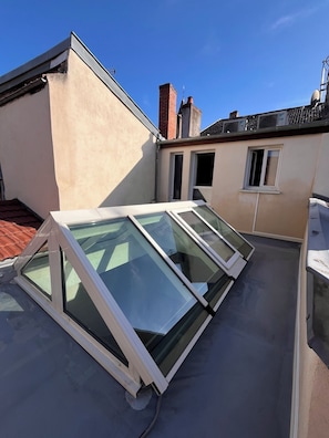 A rooftop with skylights and a red-tiled roof. - DOUCE NUITS (Nuits-Saint-Georges)