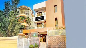 A modern townhouse with a sign reading 'TOWNHOUSE,' a gated entrance, and a staircase leading to the entrance. - Suite Vijaya Residency (Visakhapatnam)