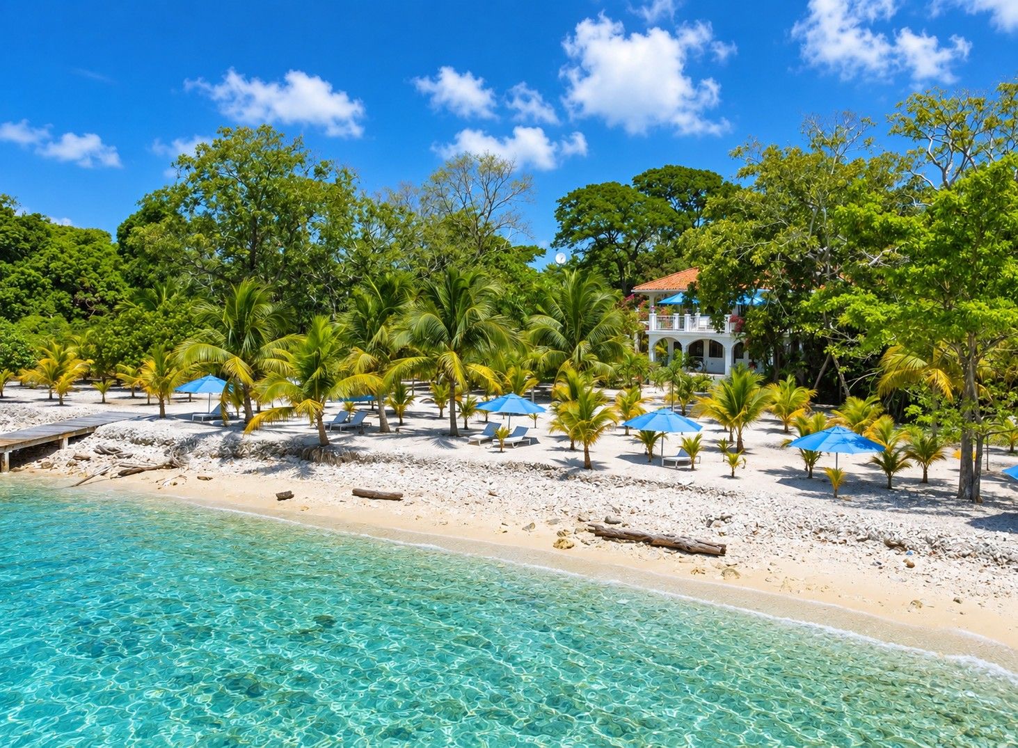 A beach with clear turquoise water, palm trees, and a building with a red roof.