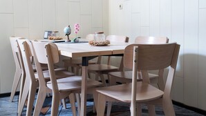 A dining area with a round table, wooden chairs, a globe, and a framed picture on the wall. - revLIVING OCTAVUS for up to 7 guests in the idyllic wine village of Hohenwarth-Mühlbach (Hohenwarth)