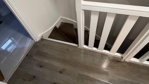 A staircase with wooden steps and white railings.