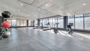 A spacious gym with exercise equipment, large windows, and a clean, modern design. - Wonderful 1BR Retreat with Balcony in Oak Park (Oak Park)