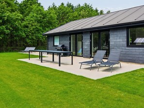 A modern building with a patio area, a grill, and two lounge chairs. - "Biergh" - 30km from the sea by Interhome (Toftlund)