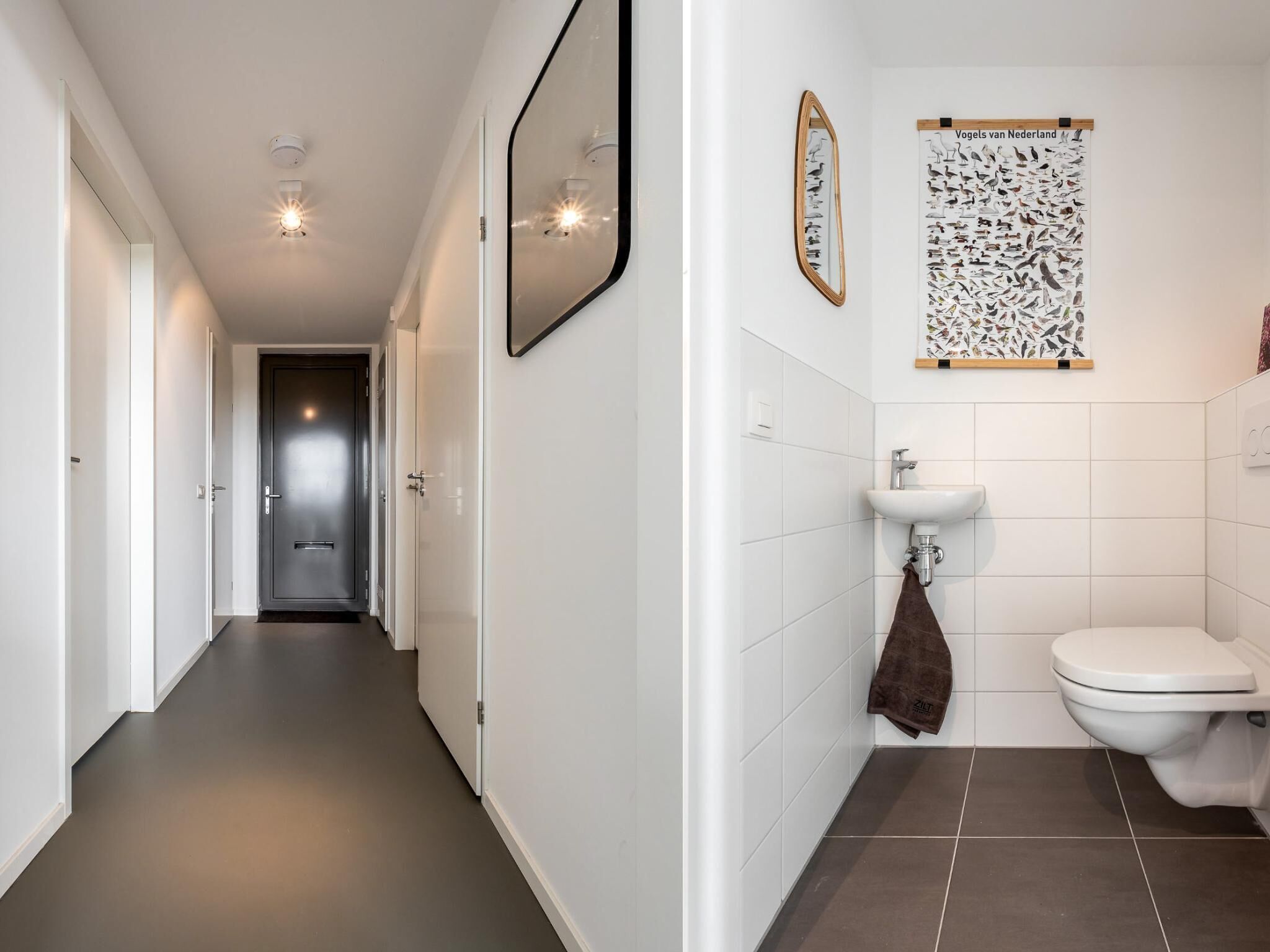 Ein Flur, der zu einem Badezimmer mit Toilette, Waschbecken und Spiegel führt.