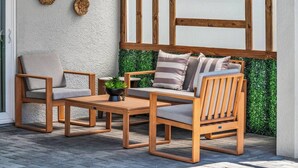 A wooden outdoor seating area with a sofa, two armchairs, and a coffee table. - Themed 7BR Villa | Lion King · Frozen · Minions | Mario Game Room | Pool & Spa (Clermont)