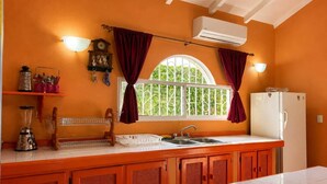 A kitchen with a window, a refrigerator, and a sink. - Painted house- 4 pax, 4 min from the beach (Las Galeras)
