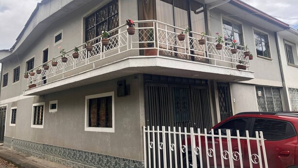 A two-story building with a balcony, windows, and a gated entrance. - Room-h6 Exceptional Location Near the Hi (Popayán)
