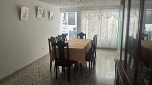A dining area with a table and chairs, a patterned floor, and a view through a window. - Room-h6 Exceptional Location Near the Hi (Popayán)
