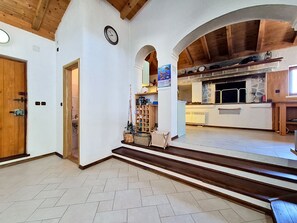 A spacious interior with a wooden ceiling, a kitchen area with stone countertops, and a staircase leading to another level. - Vacation home Blue by Interhome (Drvenik Mali)