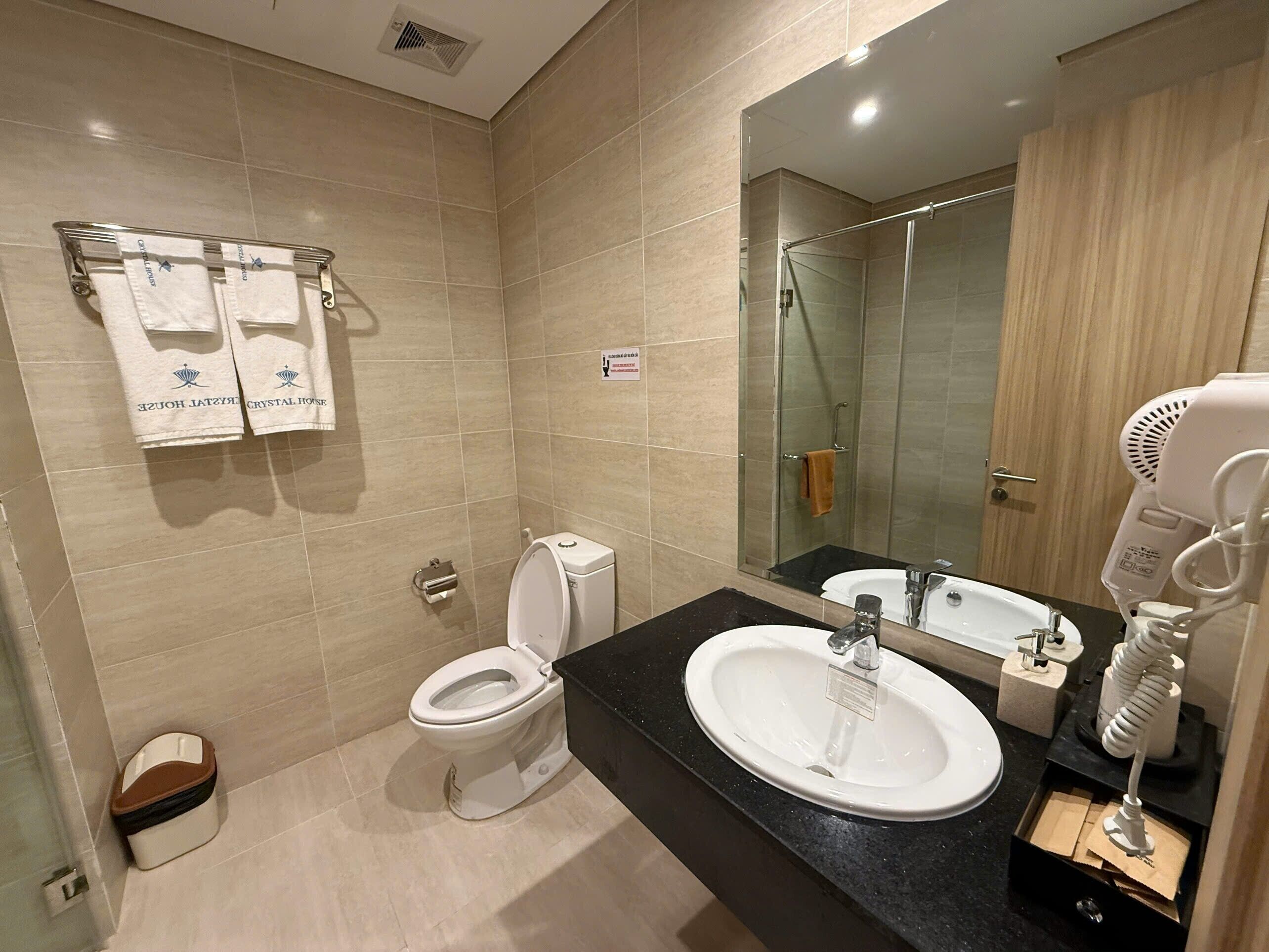 A modern bathroom with a toilet, sink, and shower.