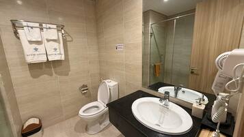 A modern bathroom with a toilet, sink, and shower.