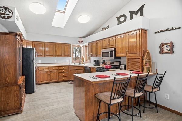 Kitchen | Breakfast Bar Seating & Stainless Steel Appliances | Open Layout with Skylights