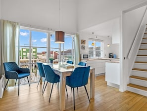 A modern kitchen with a dining area, large windows, and a staircase. - "Björk" - 10m from the sea by Interhome (Ebeltoft)