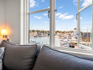 A room with a view of a marina, a sofa, and a lamp. - "Björk" - 10m from the sea by Interhome (Ebeltoft)