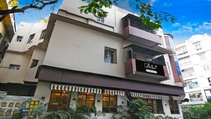 A multi-story building with a sign reading 'Collection Complete Services.' - Classic With Twin Bedrm Guest Home (Kolkata)
