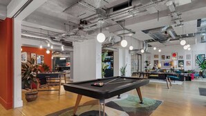 A modern indoor space with a pool table, ceiling pipes, and hanging lights. - 1 Min Walk to Wembley Stadium Sleeps 10 Gym (London)