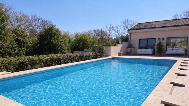 A rectangular swimming pool with clear blue water, surrounded by a tiled deck. - Elegant Villa With Pool (Senigallia)