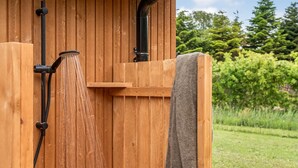 A wooden sauna structure with a towel hanging on the side. - "Sharina" - 320m to the fjord by Interhome (Storvorde)