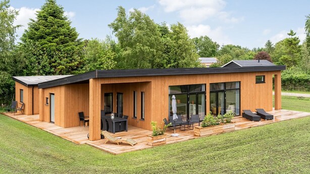A modern wooden house with a deck, outdoor seating, and large windows. - "Sharina" - 320m to the fjord by Interhome (Storvorde)
