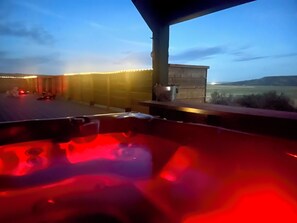 A hot tub with a view of a landscape.